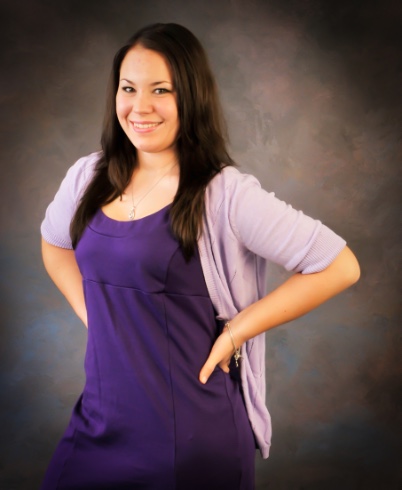 graduating senior girl posing for senior pictures in studio on masters background