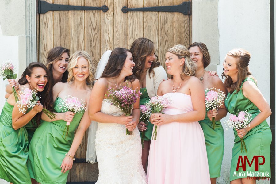 Pink rose and baby's breath bouquets pop against green strapless bridesmaid dresses. © Aura Marzouk Photography. 