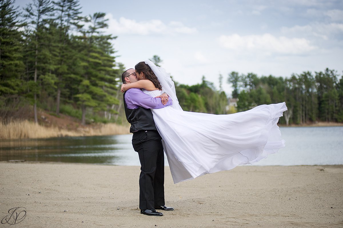 photo of bride and groom twirling on beach