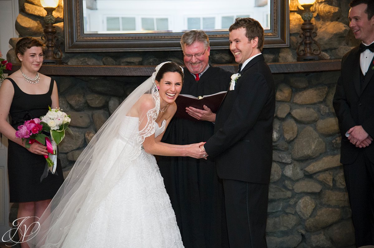 bride laughing at alter, candid moment of bride during ceremony, crooked lake house wedding ceremony photos, wedding ceremony photos, bride and groom at alter, albany wedding photographers