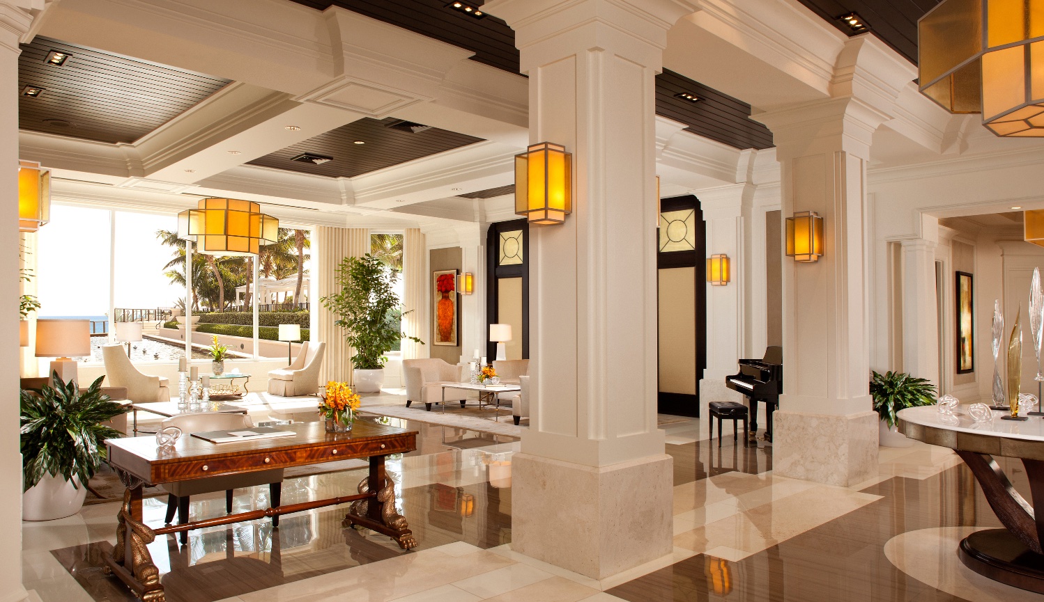Ritz-Carlton Hotel Lobby in Palm Beach Florida with all white modern Interiors and marble floors and beautifully hand selected lighting.