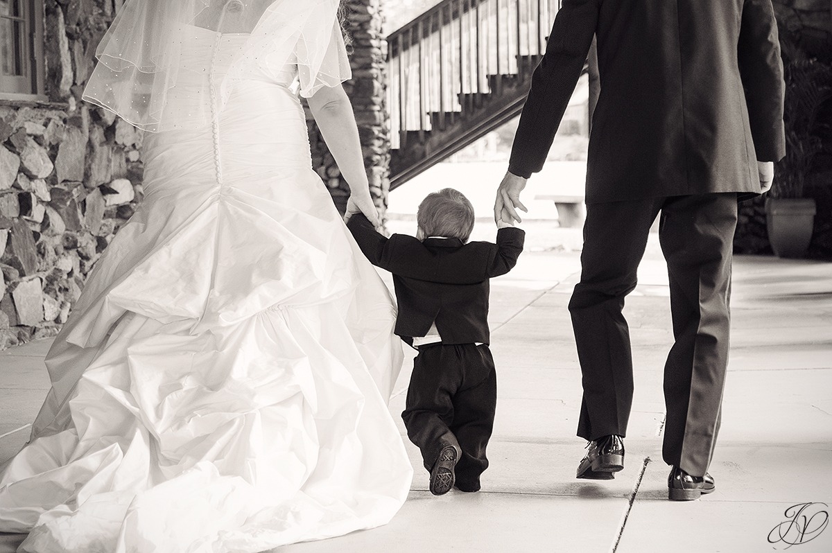 sweet photo of son walking with bride and groom