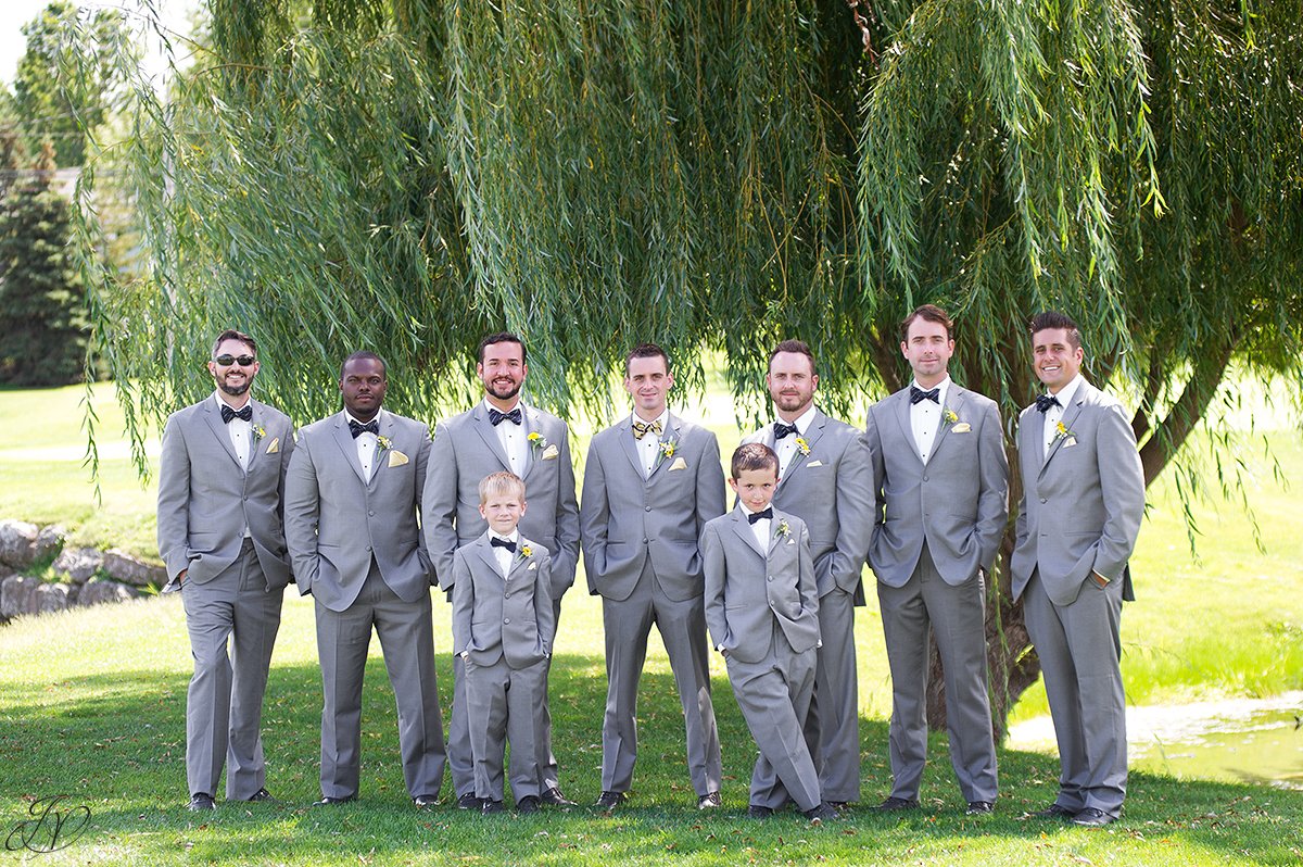 grooms men in bow ties and gray suits