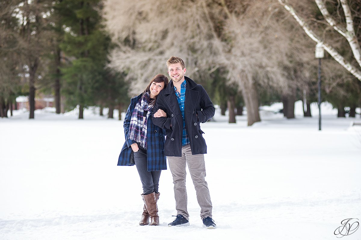 winter photo of cuddling engaged couple