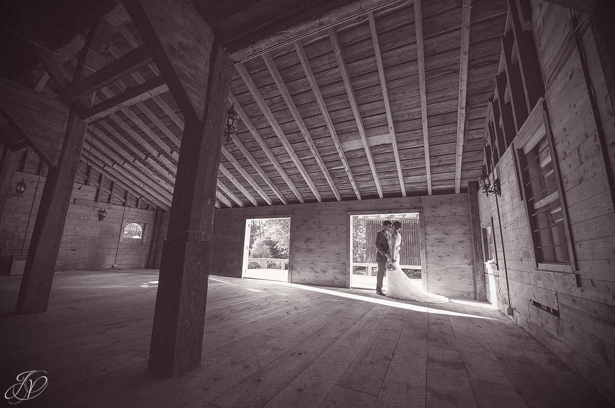 romantic photo of bride and groom in a barn