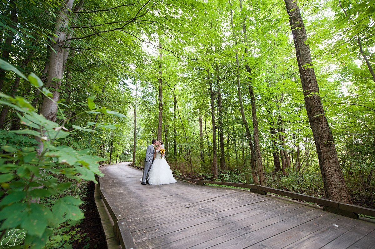 bride and groom on bridge walkway Timberlodge at Arrowhead Golf Club