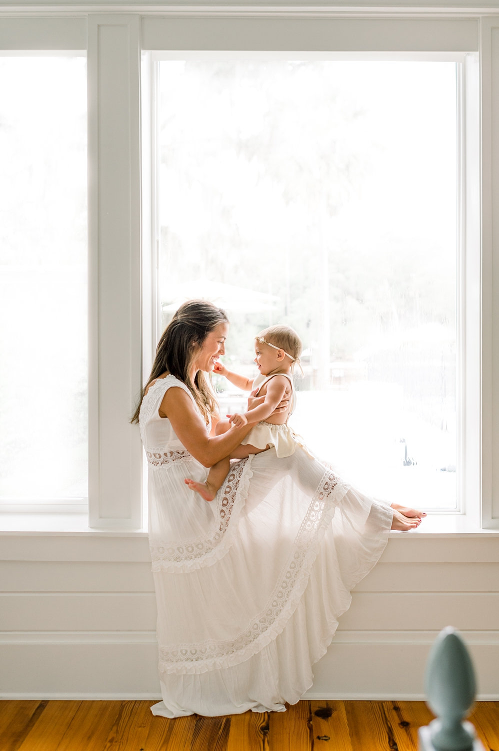 motherhood window portrait, backlit photo of mom and baby, Ryaphotos