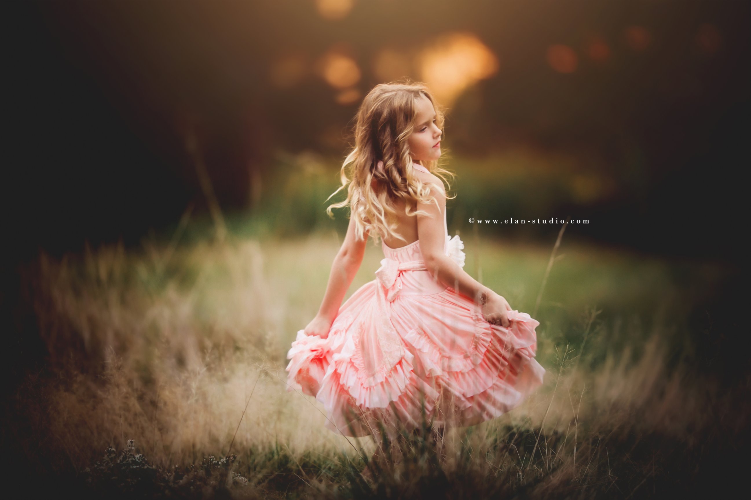 girl twirling, pink dress, bokeh