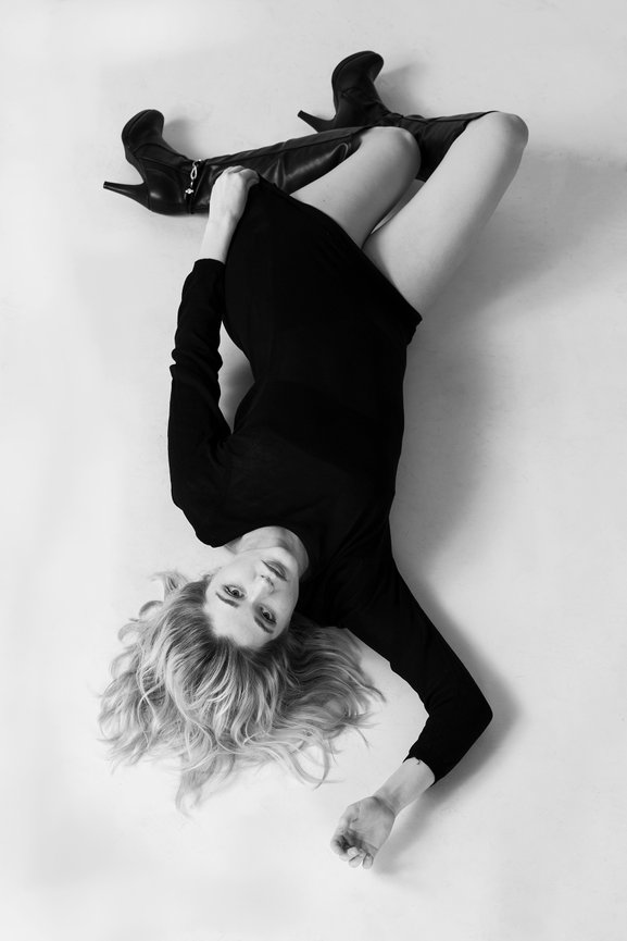 Fashion portrait of a model in Charleston,SC lying on the floor during a studio portrait session, Image is created by Heather Johnson Photography