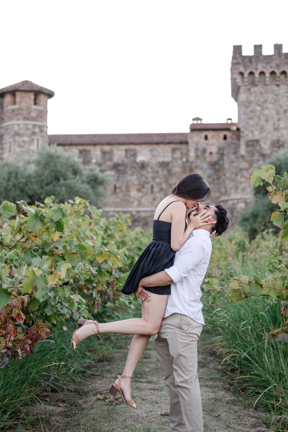 Man lifting woman after proposal at Castello di Amorosa in St Helena photographed by Studio J Portraits