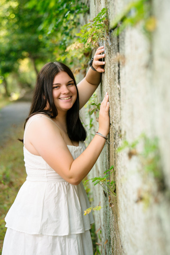 senior girl wearing a white dress for her senior pictures