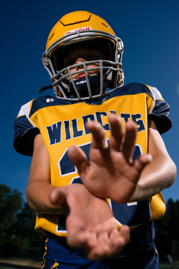 football player for shenango wildcats being photographed on the field with mercer pa photo studio