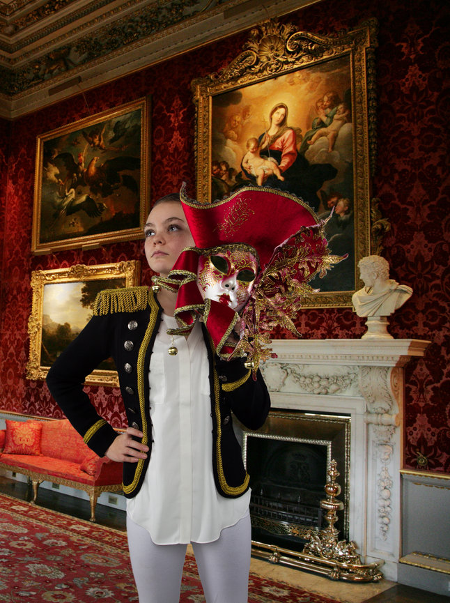 Composite image of a women holding a Venetian mask.