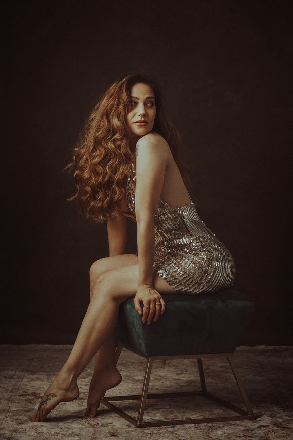 Sophisticated Las Vegas studio photography by Adam Trujillo, capturing beauty with professional lighting and makeup. This fancy portrait session the client has big beautiful curly hair and a elegant sequin dress fit for a night out in fashion.
