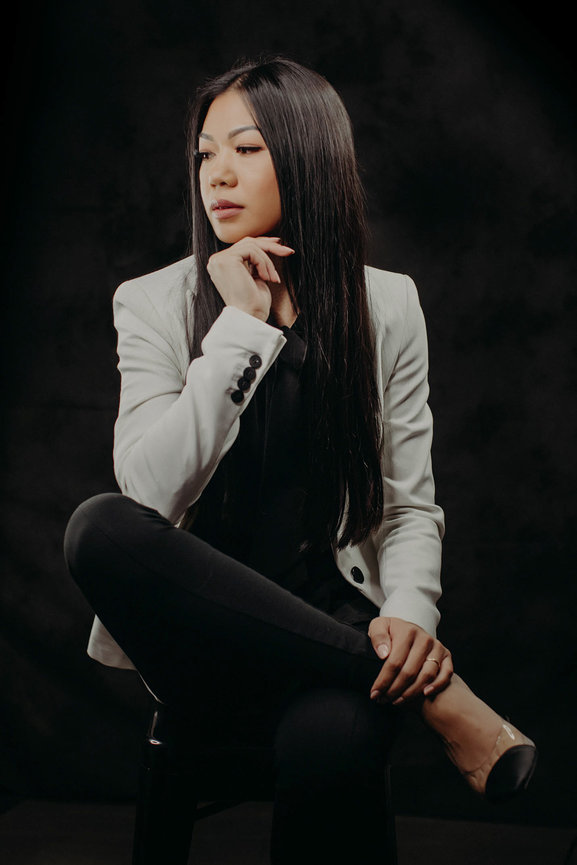 Professional branding headshot in studio with white sport coat and glossy black hair and wardrobe. Las Vegas Professional headshots and team portraits in studio with Adam Trujillo.
