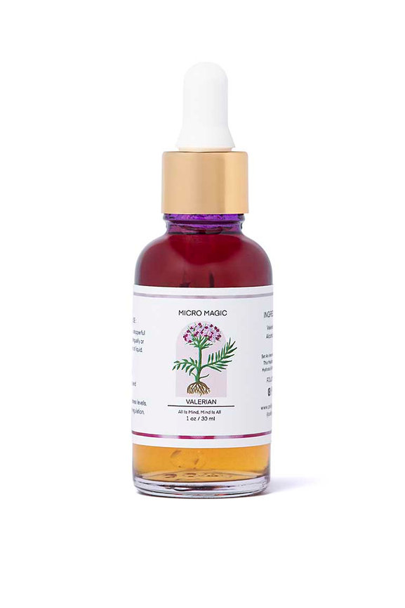 Red and orange dropper bottle of mushroom tincture on white background