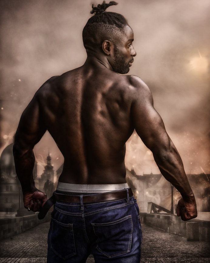 Fine Art Painterly Portrait showing a muscular shirtless man standing with back to camera in a smoky city street at dusk