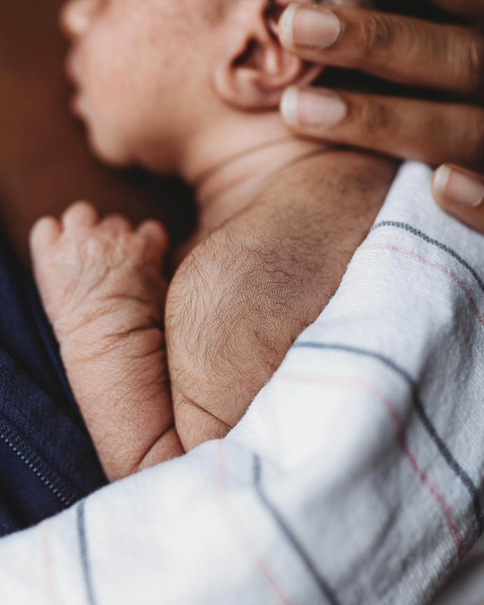 A close up of the fuzz on a newborn baby's shoulder at a newborn photography session in New Jersey.