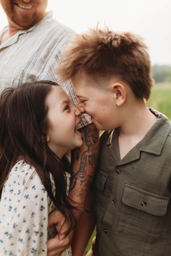 A brother and sister touching noses during their New Jersey family photo session.