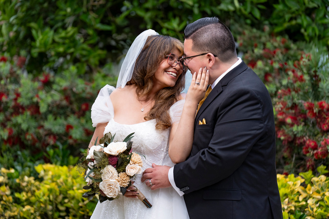 Bride and groom sharing a joyful moment outdoors