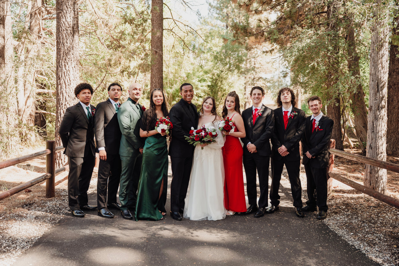Wedding party group portrait in a wooded outdoor setting