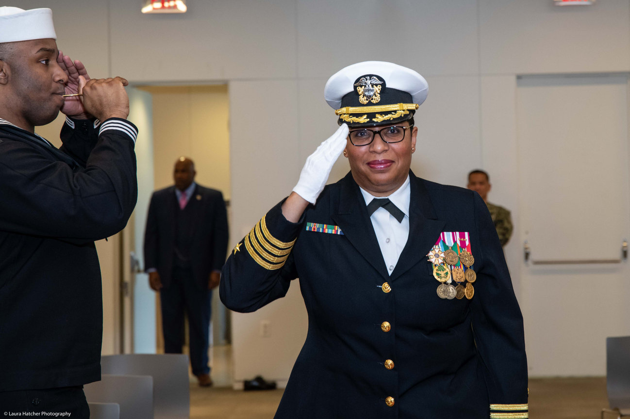 US Naval Officer saluting at her retirement ceremony