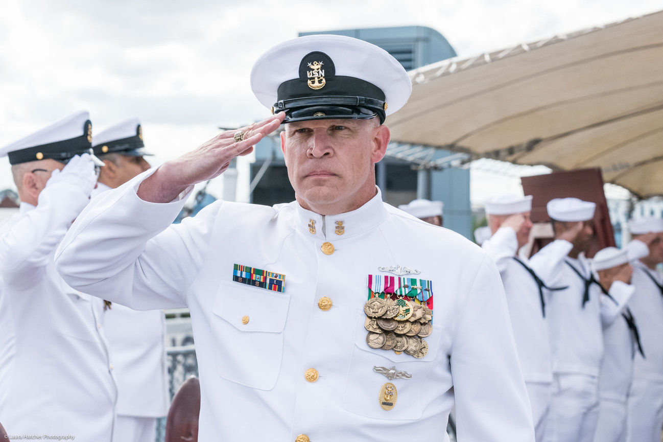 A Master Chief saluting at his retirement ceremony
