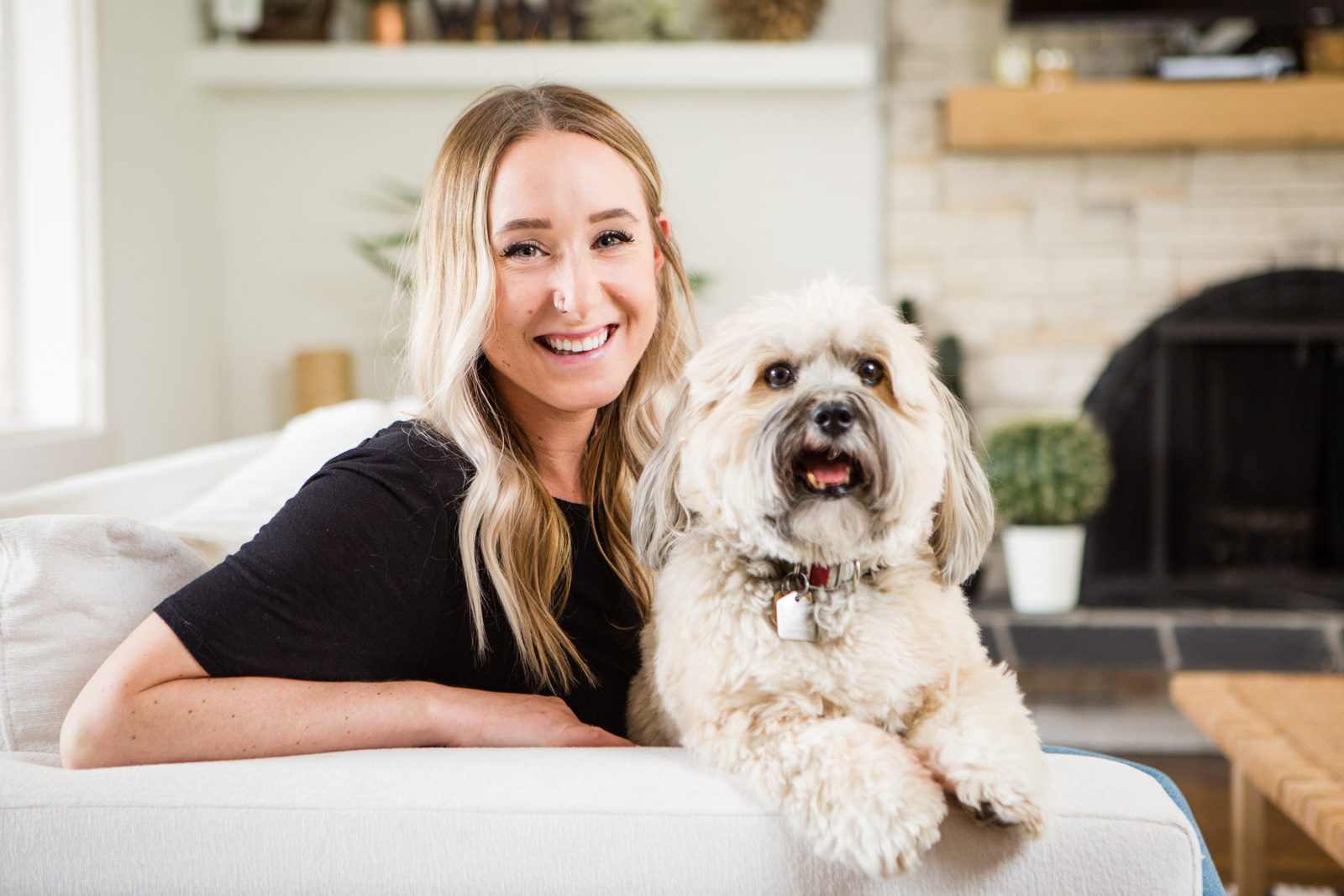 A personal brand lifestyle photo of a woman smiling with her pet