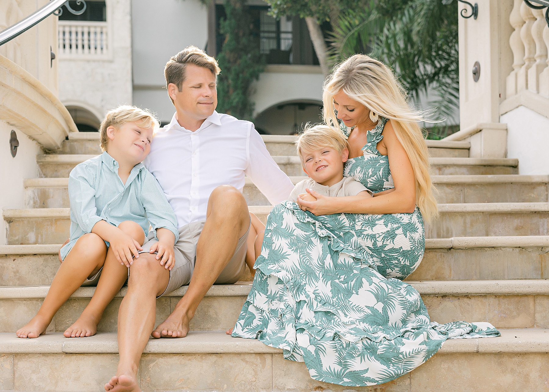 family in neutral colors sitting on steps at the cloister sea island
