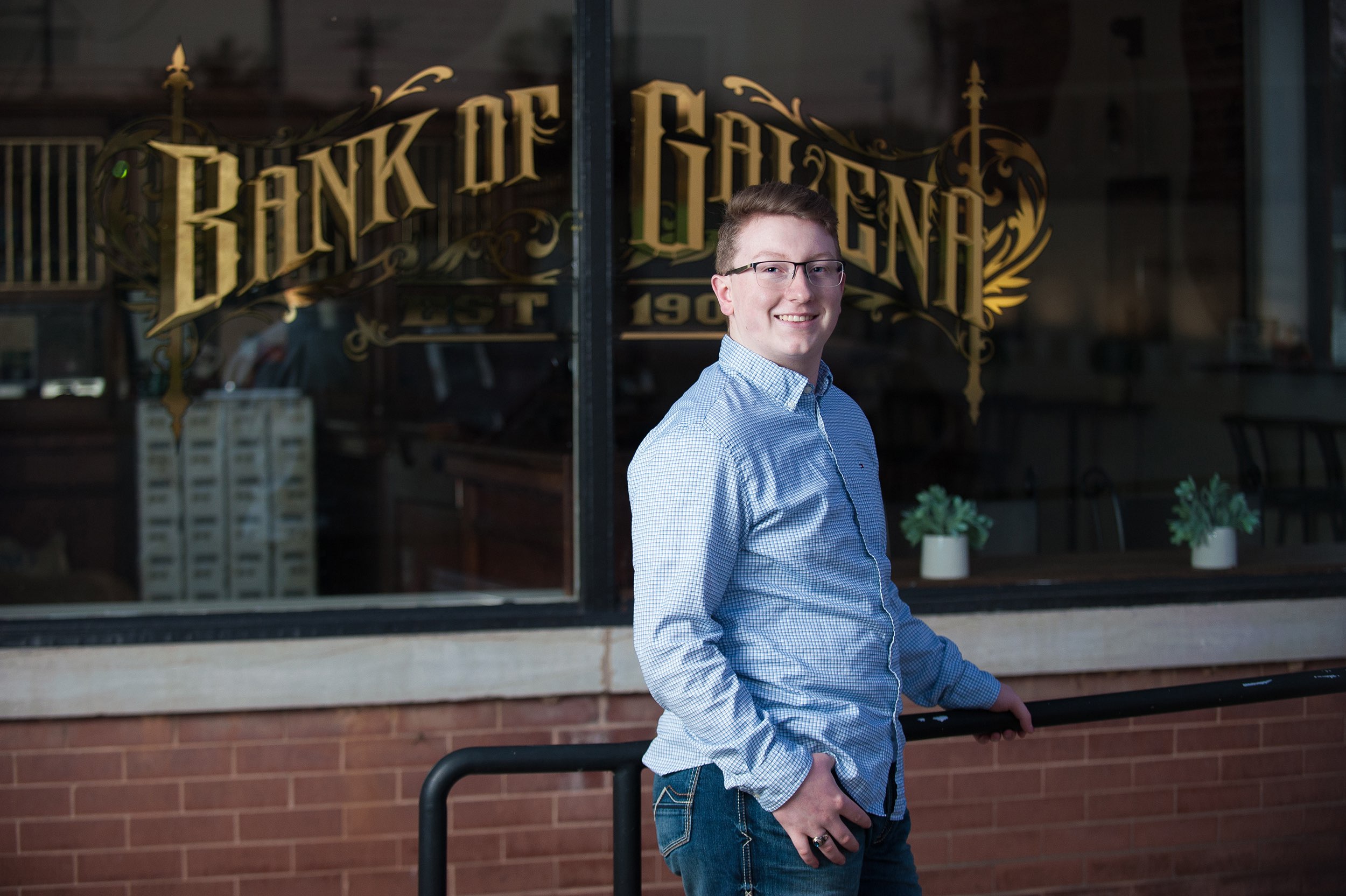 Senior guy in blue shirt standing in front of The Bank of Galena.