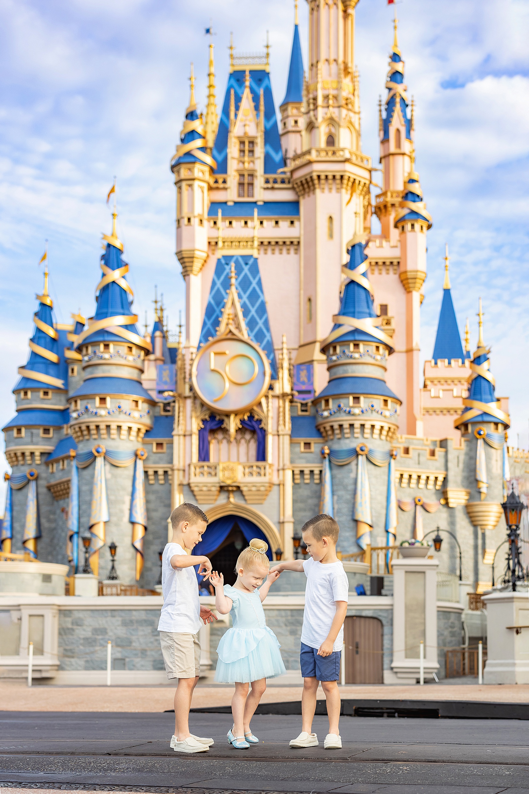 siblings standing in front of Cinderella's Castle at Disney World Magic Kingdom Orlando Florida