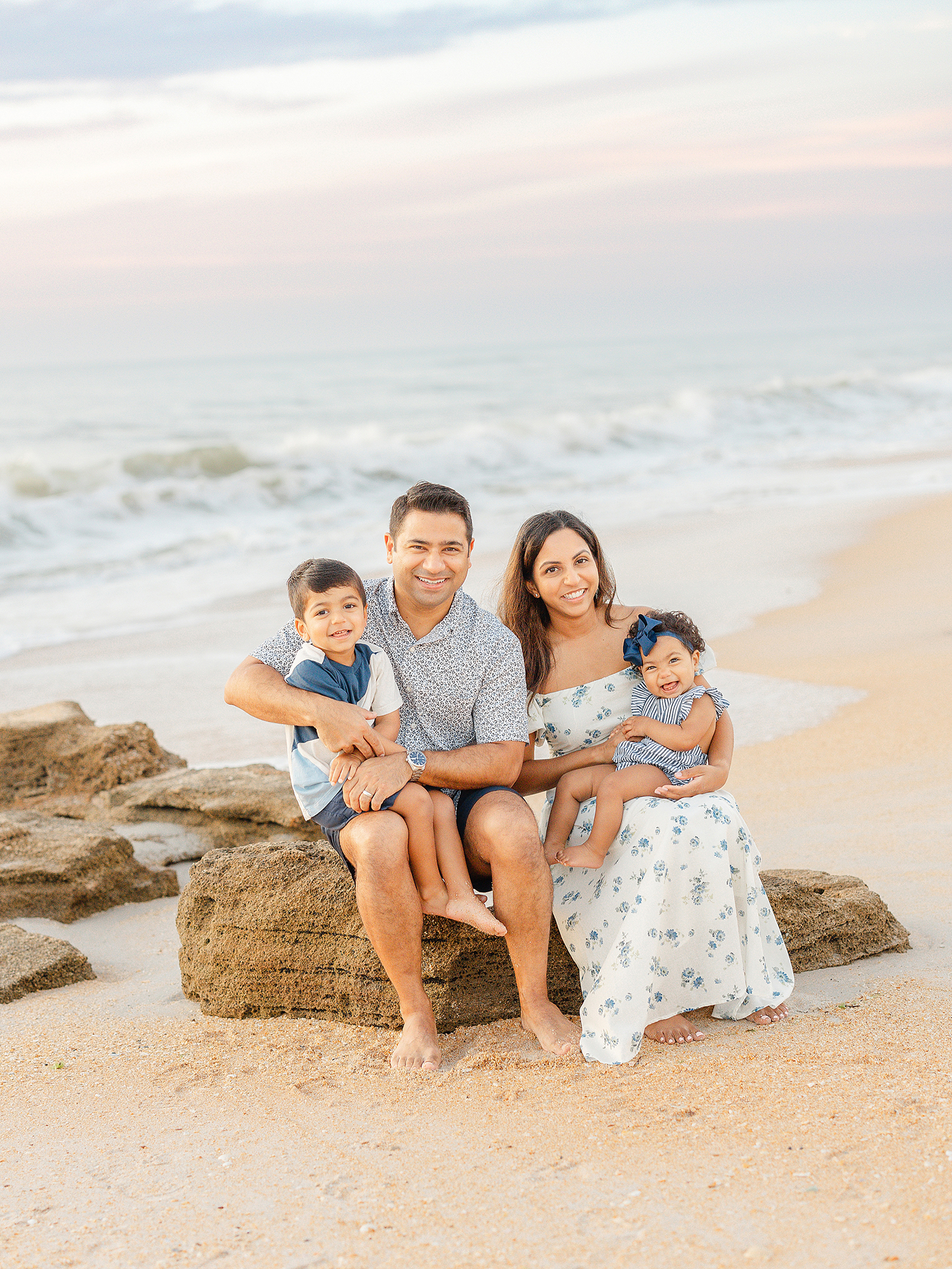 A family beach portrait with pastel skies at sunrise in St. Augustine 