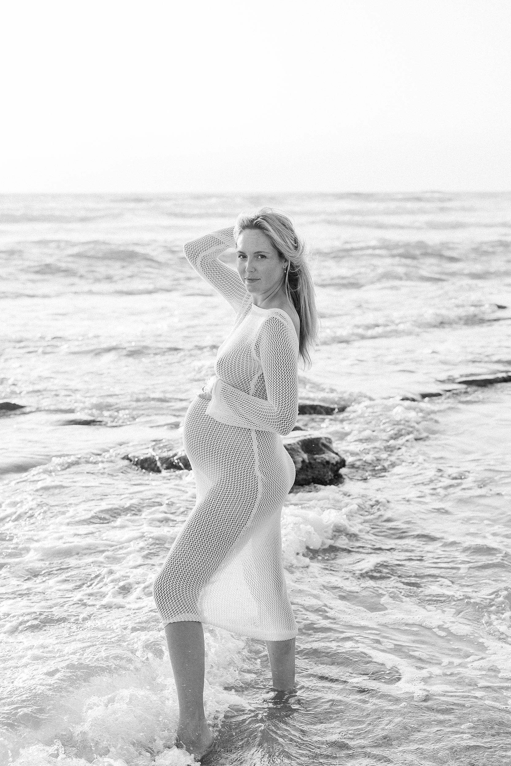 Morning maternity session in St. Augustine Beach with sheer white dress.