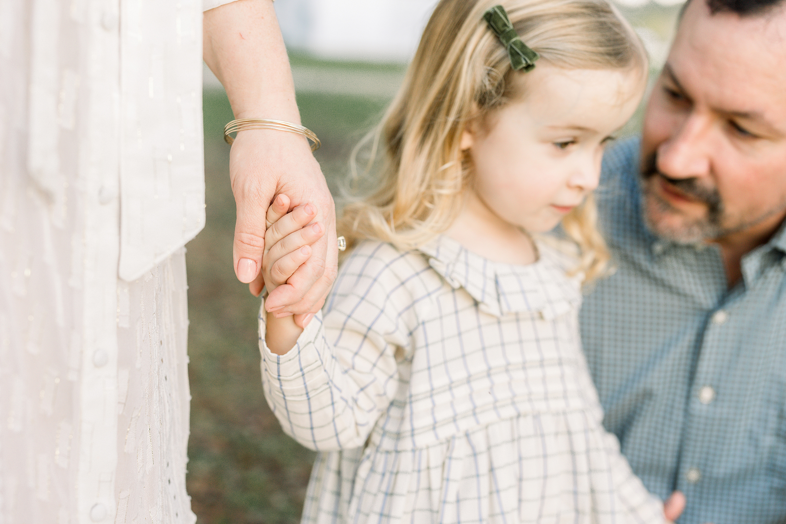 A fall family portrait of a little girl with her parents at Congaree and Penn farm.