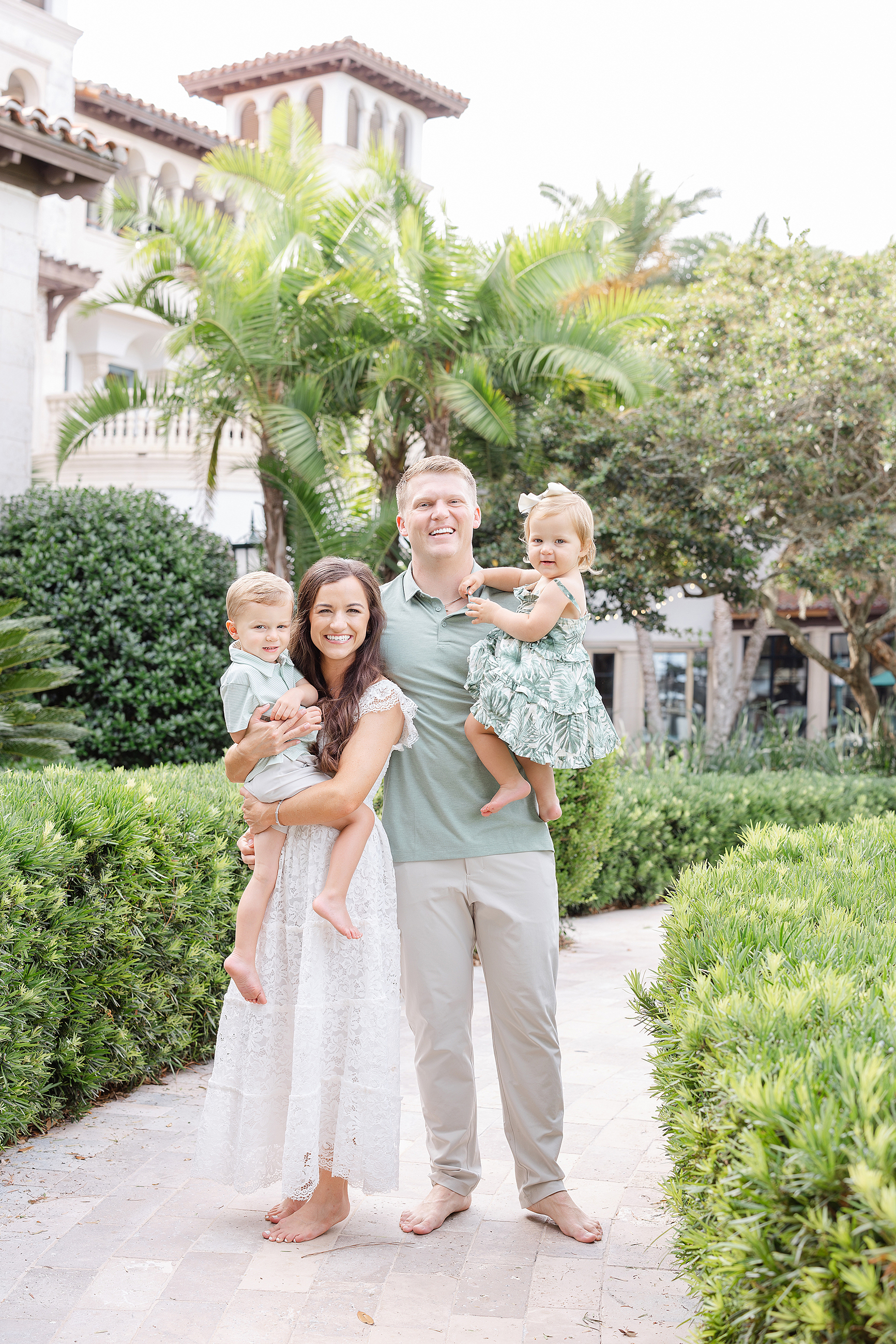 A family of four stands on the grounds of The Cloister.