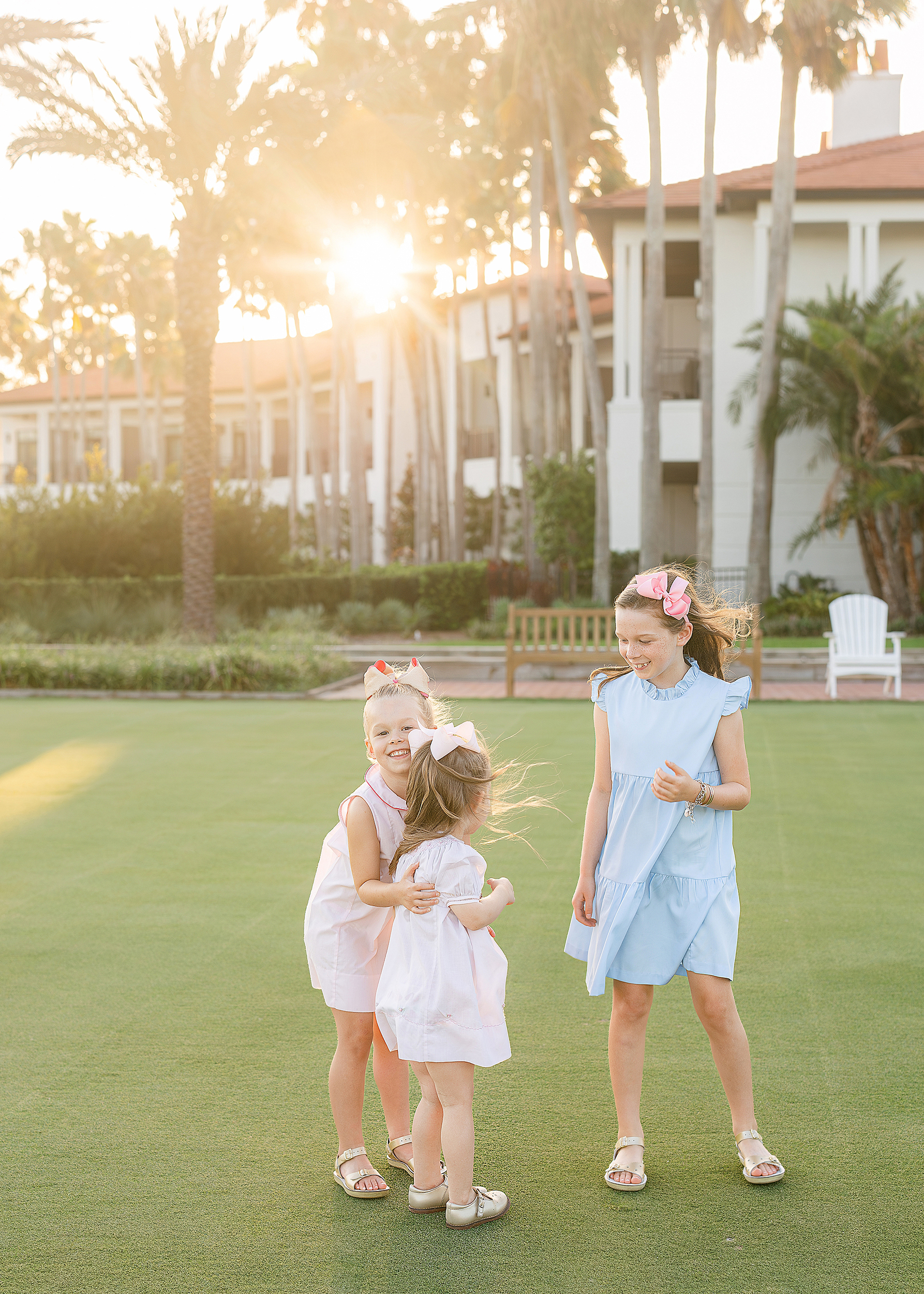 Sisters play together on the golf course at sunset at Ponte Vedra Beach, Florida.