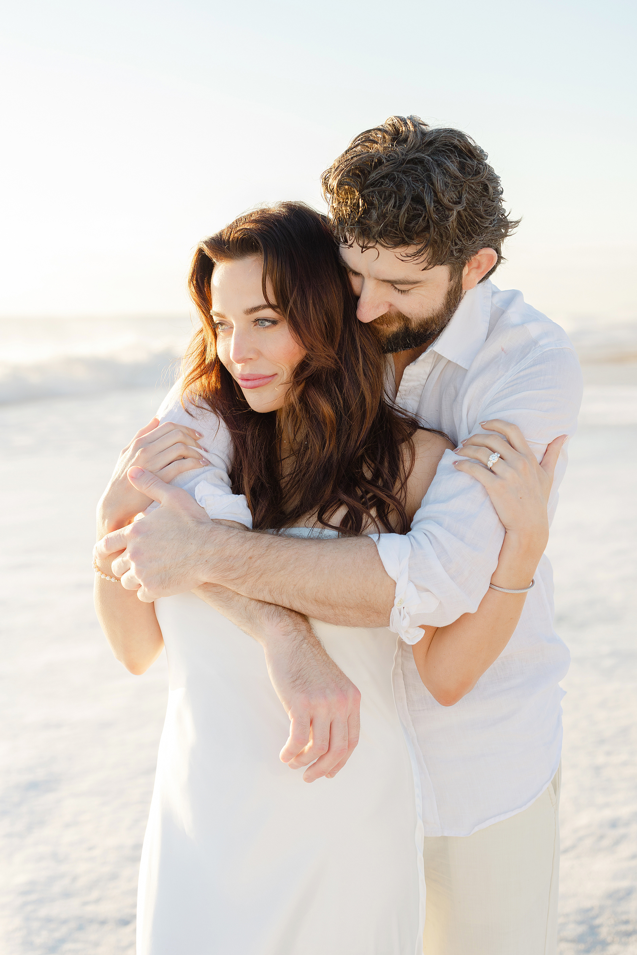 A light and airy sunrise portrait of a man and a woman on the beach of the Omni Resort in Amelia Island, Florida.