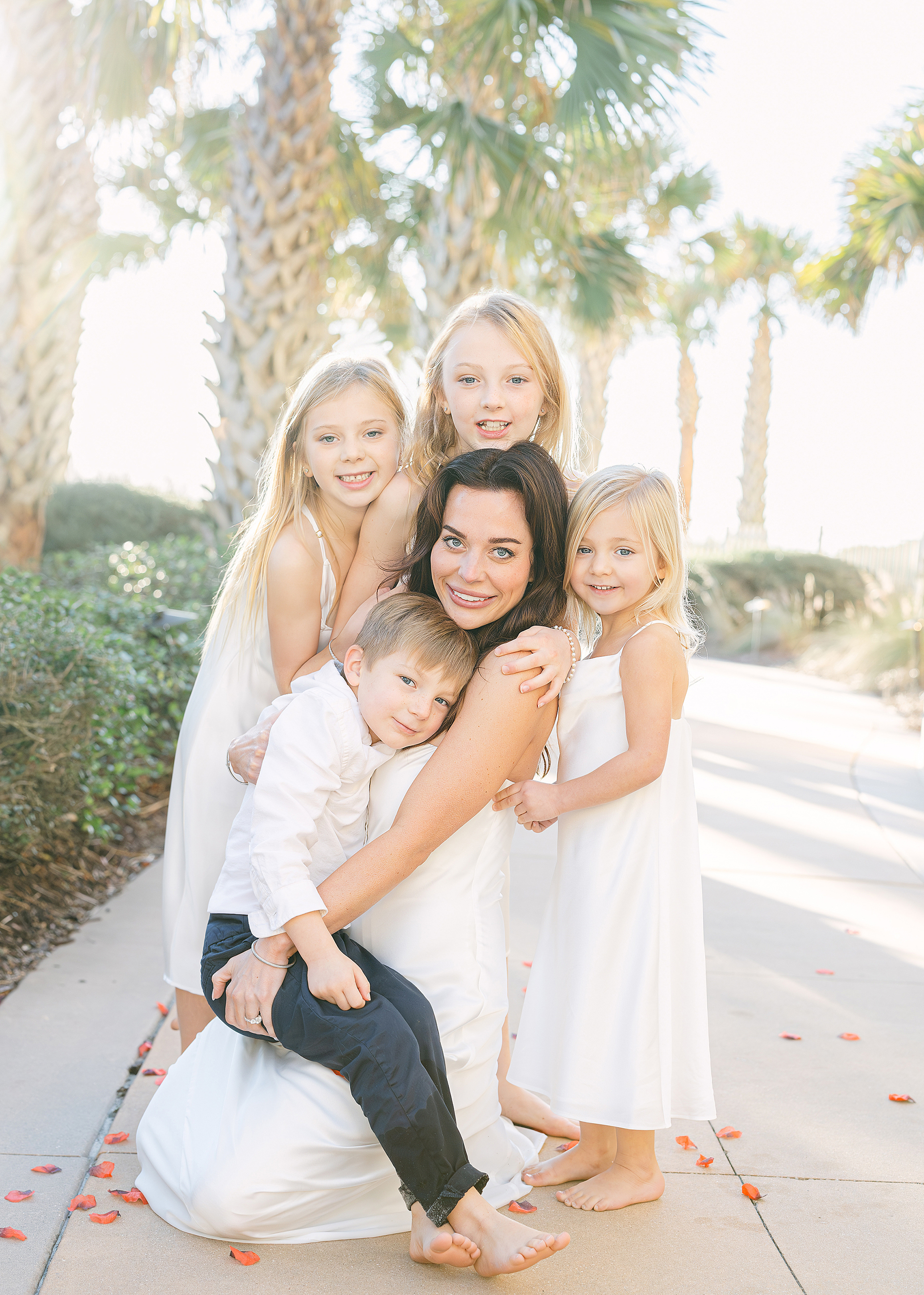 A woman holds her blended family children on her second wedding day at the grounds of the Omni Resort, Amelia Island.