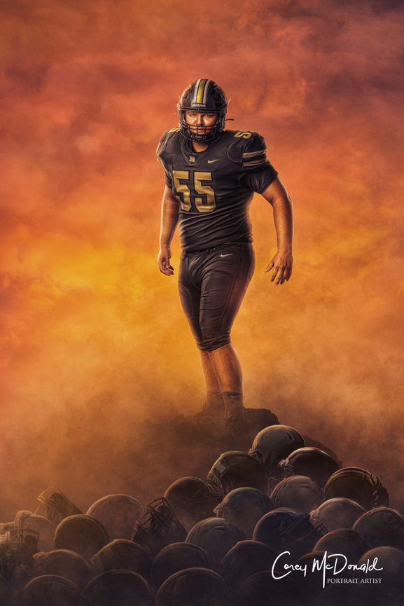 A football player in uniform stands dramatically on a pile of helmets against a fiery sky.
