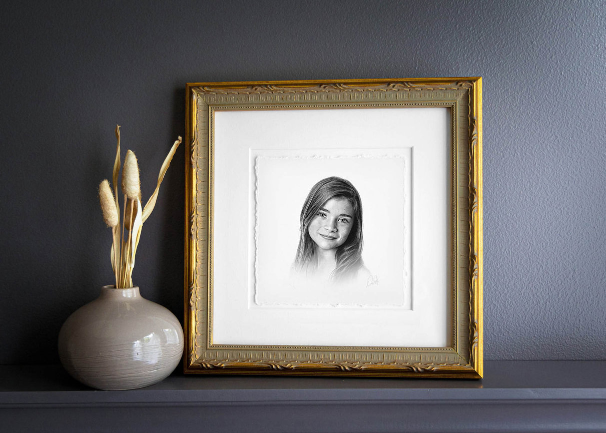 Fine art children’s portrait in charcoal, with a soft background and thoughtful gaze.