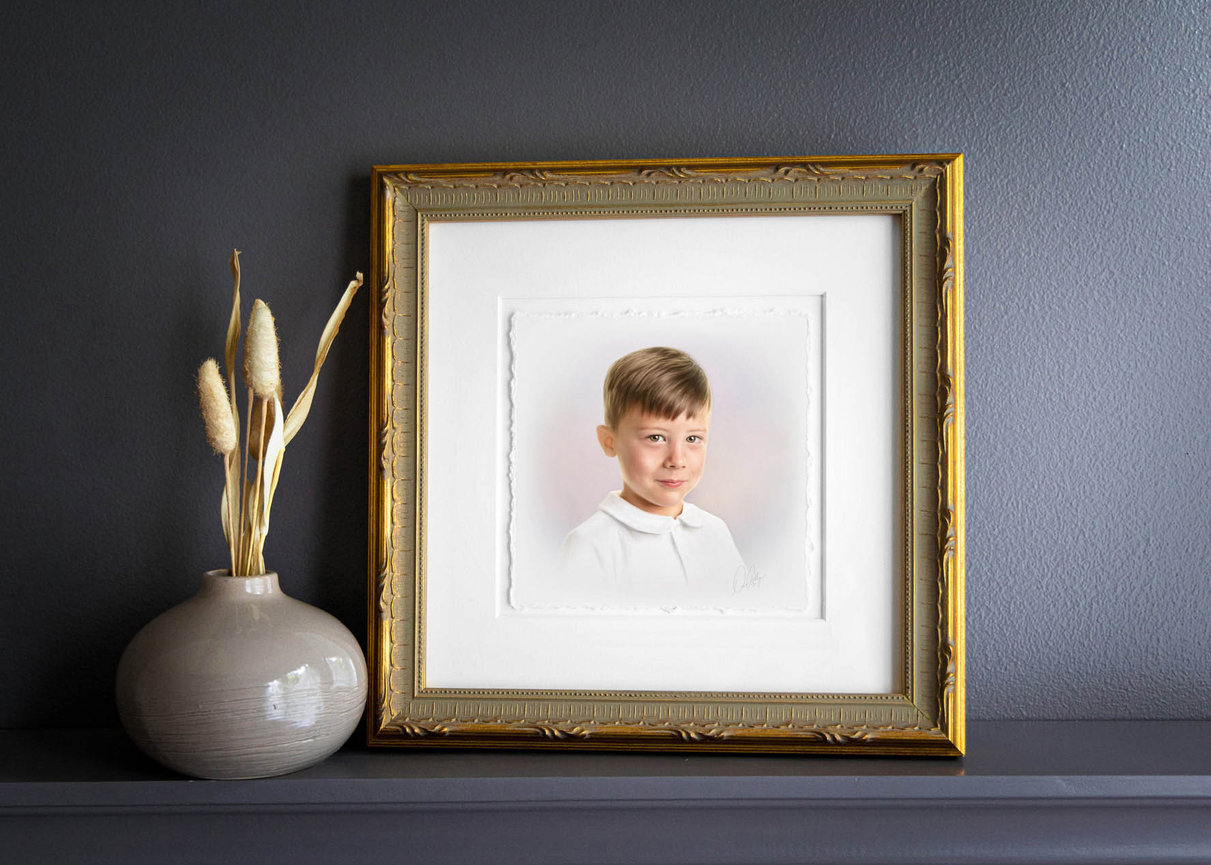 Timeless pastel head and shoulders portrait of a young boy in a white collared shirt.
