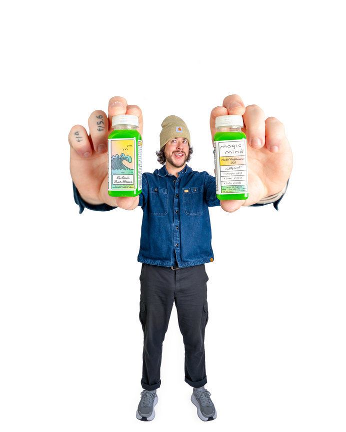 Man displaying two bottles in front of him