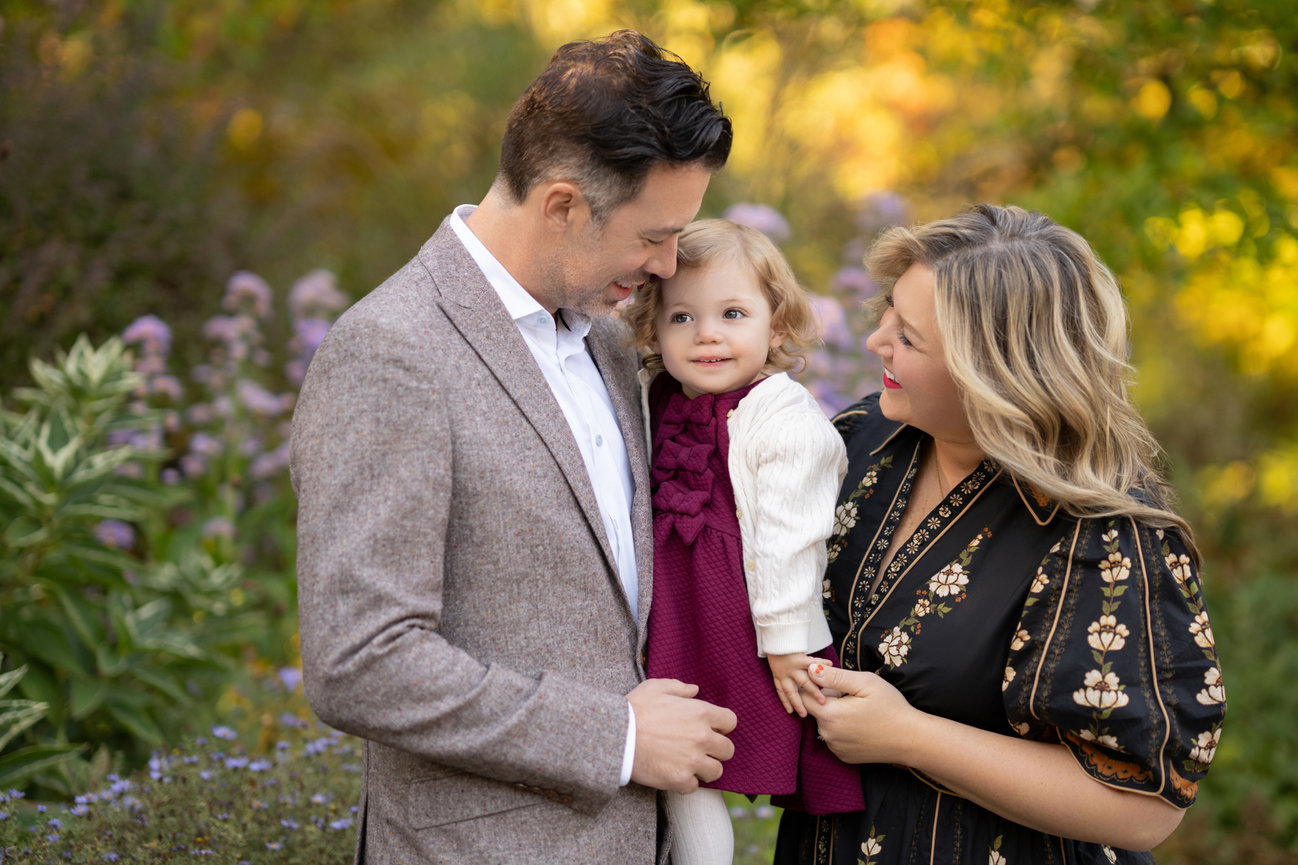 Family with a toddler in the fall garden