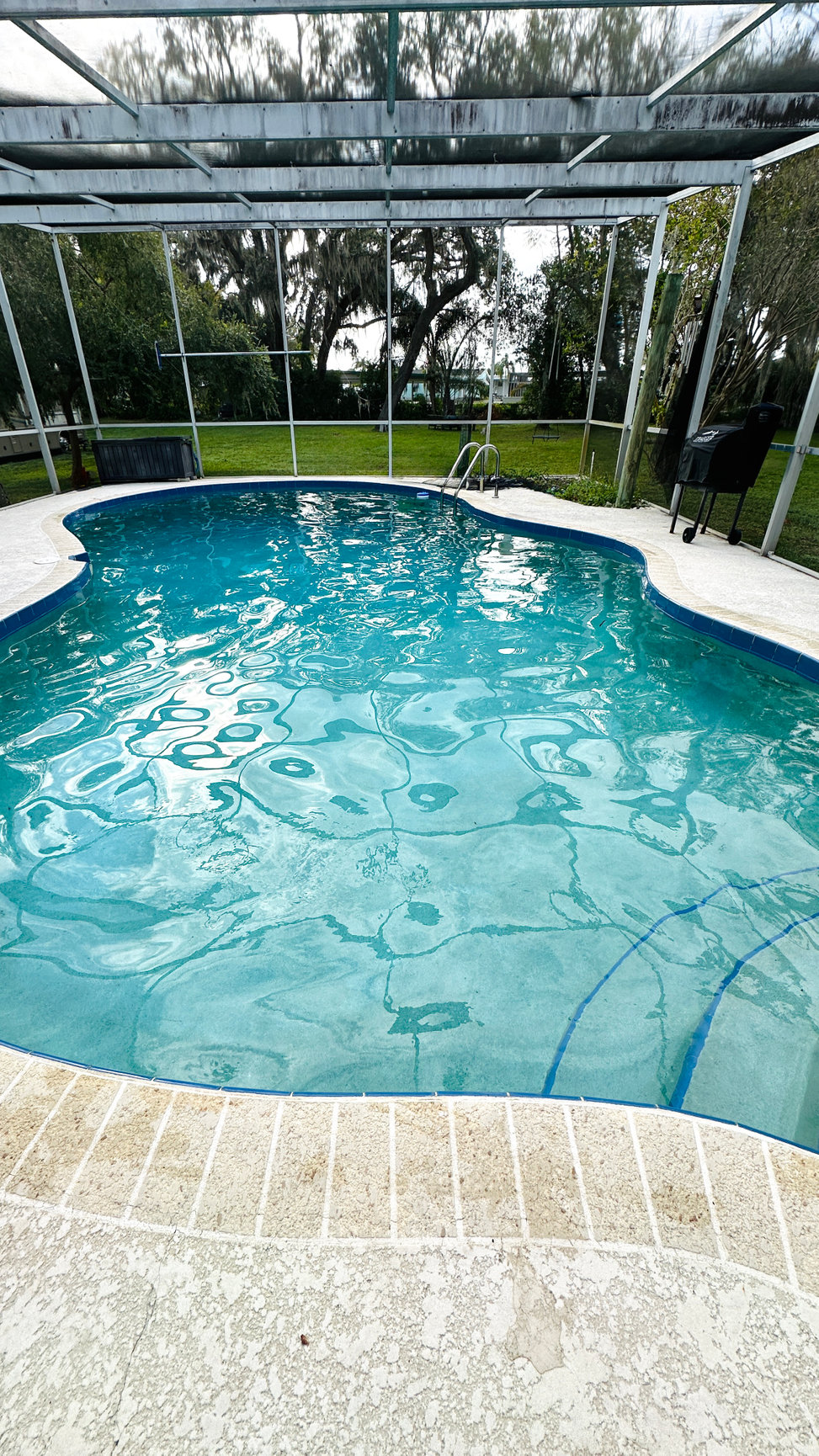 Crystal clear swimming pool after professional green pool treatment by Playa Pool Pros