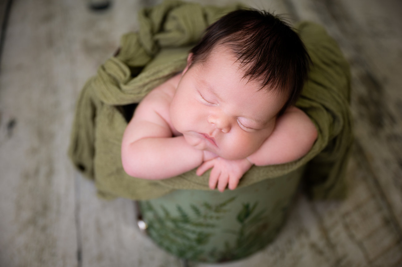 In-home newborn photography in Houston, Texas that helps parents understand the value of a customized portrait experience.