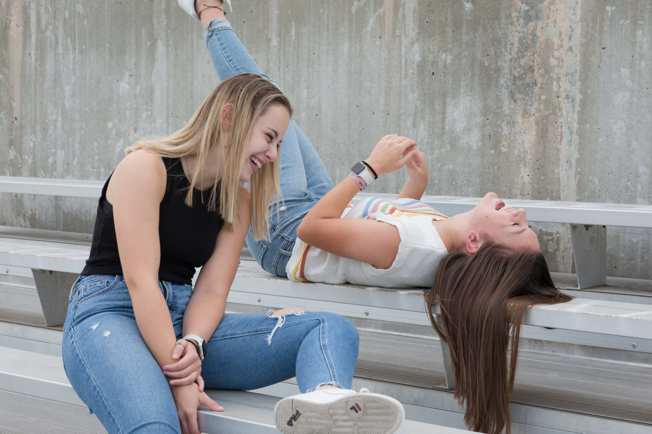 two senior girls on the Case Studios Photography Senior team hanging out on stadium bleachers in Blue Springs, MO