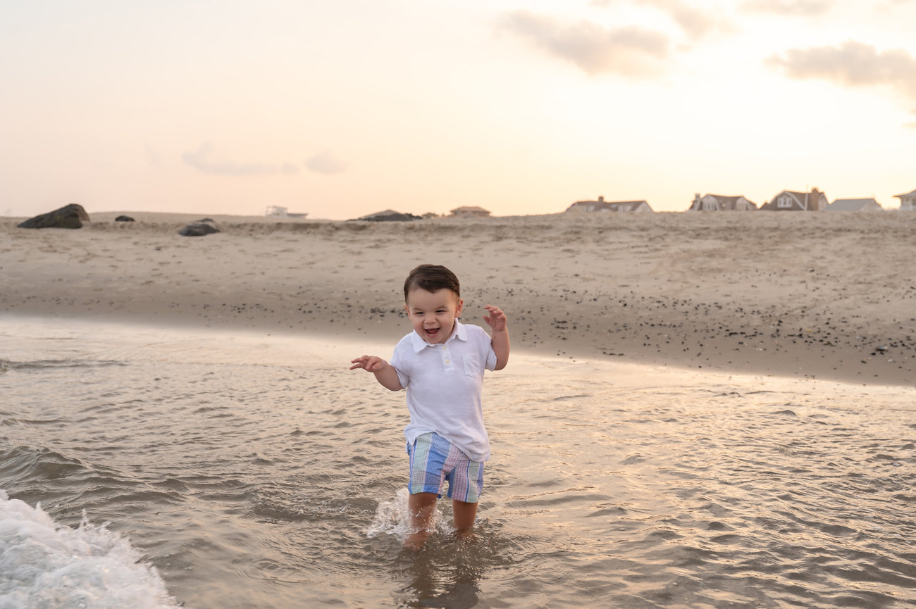 Playful toddler splashing in the Manasquan shoreline