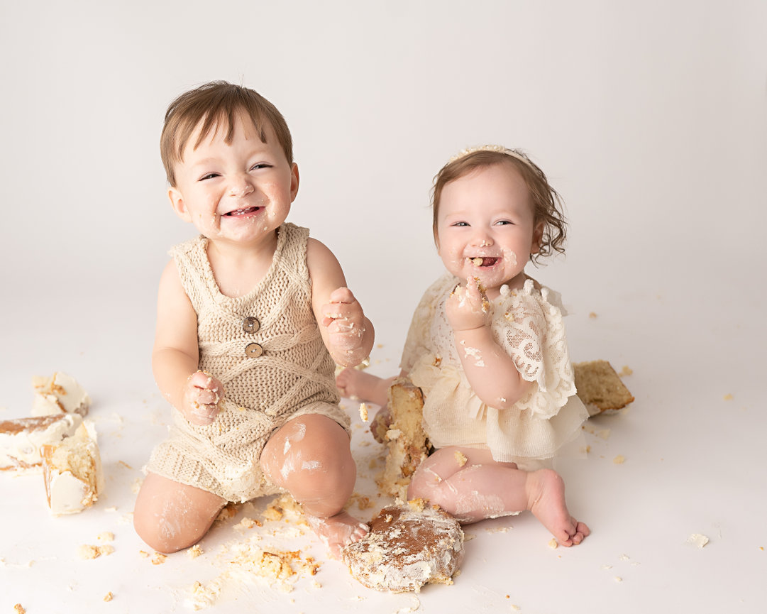 Messy cake smash with baby happy twins covered in icing in Freehold studio