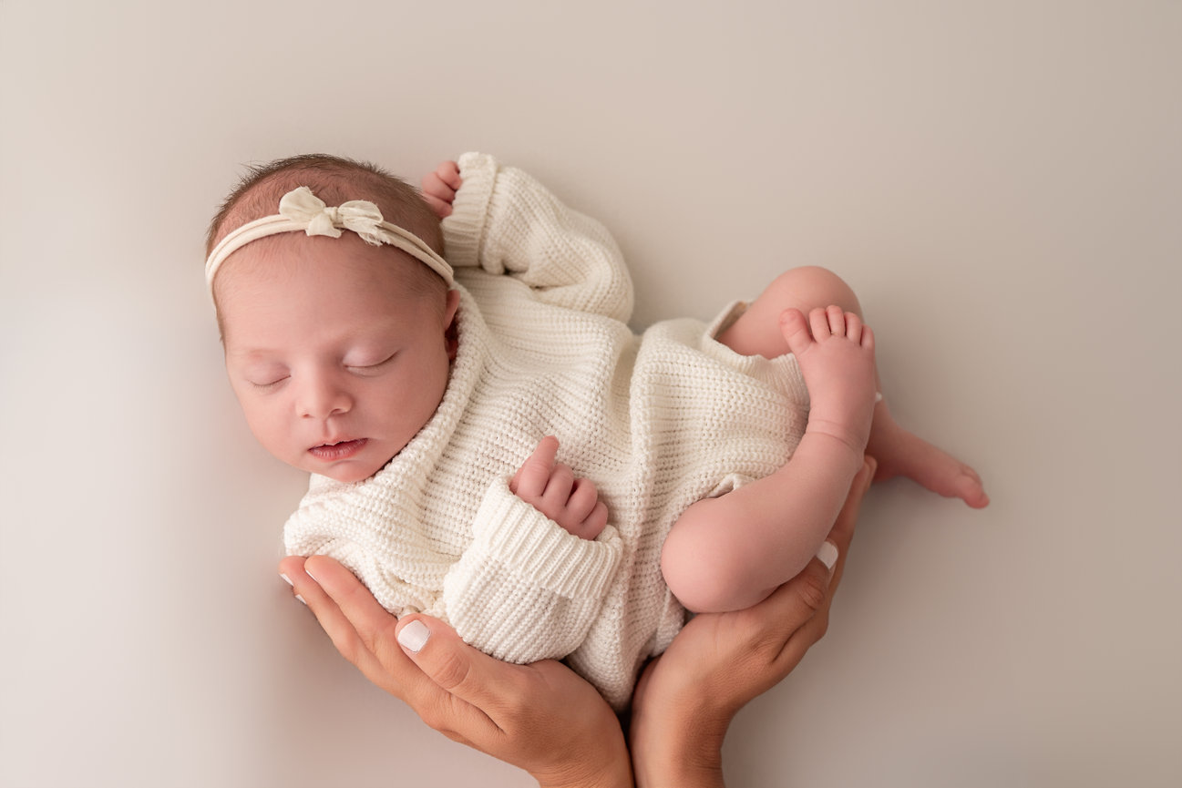 Relaxed newborn lifestyle photo shoot in soft white setting in Rumson, NJ