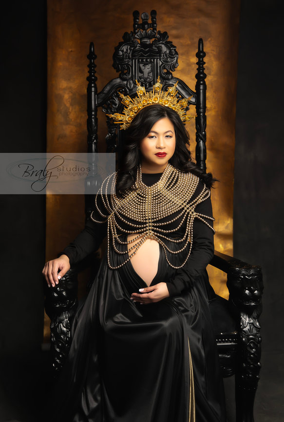 Southlake fine art portrait in studio with woman in black gown and ornate chair backdrop.